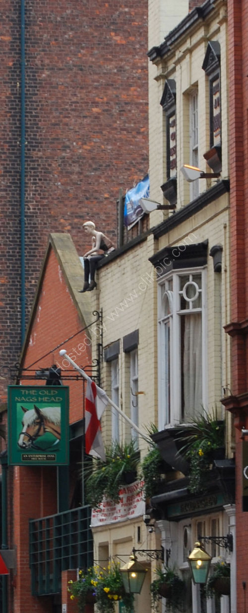 'Figure' sat on roof of Pub