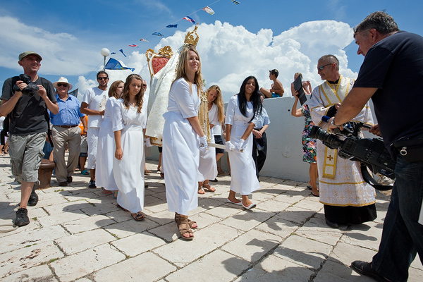 Young girls are carrying the Snow Madonna statue on handbarrows in Kukljica, island Ugljan, Croatia