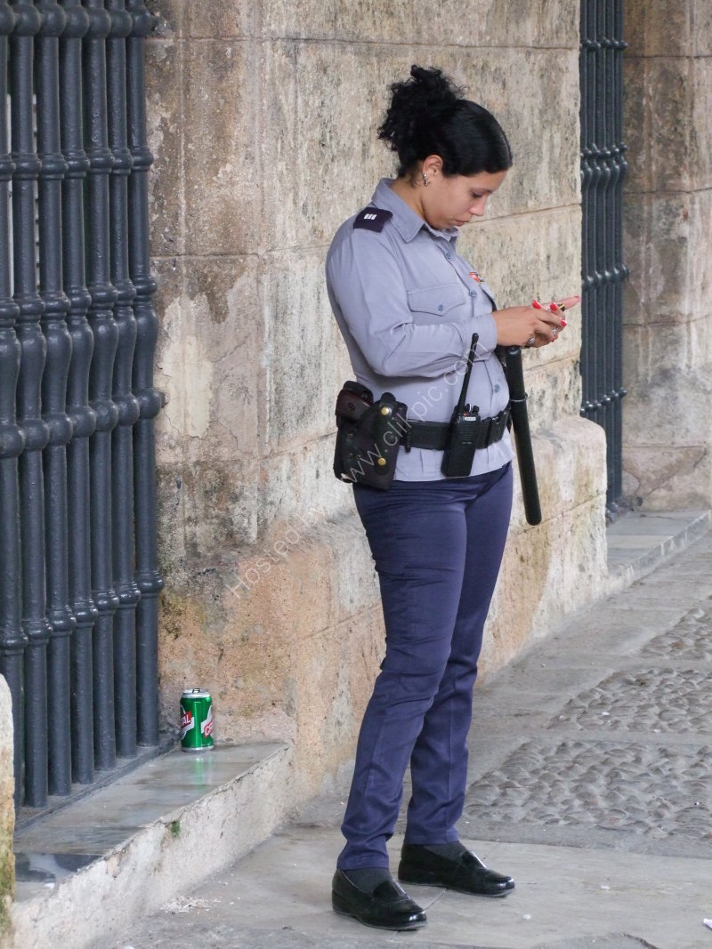 Cuban Police Woman with Gun & Painted Nails!, Plaza Armas, Havana