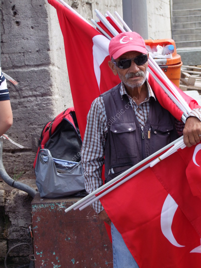 Turkish Man selling Turkish Flags in front of New Mosque, Istanbul