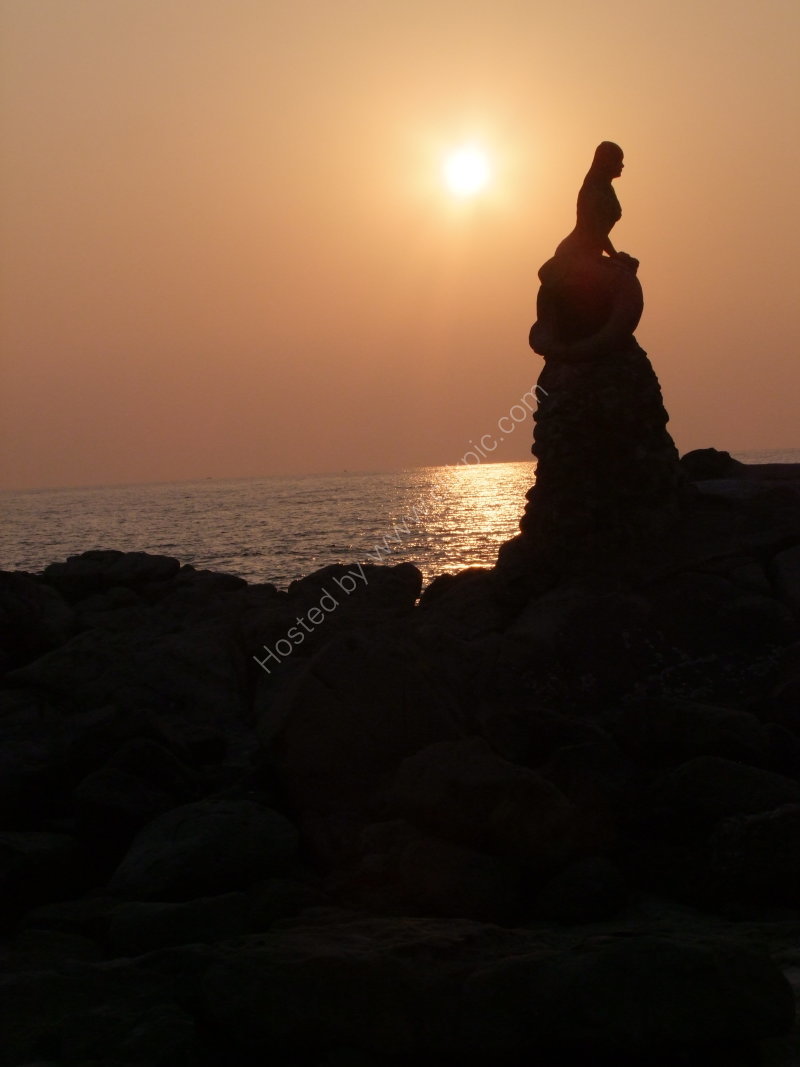 Silhouette of Mermaid on the Rock