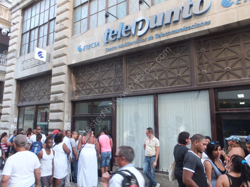 Cubans queuing to telephone at telephone exchange, Obispo Street, Havana
