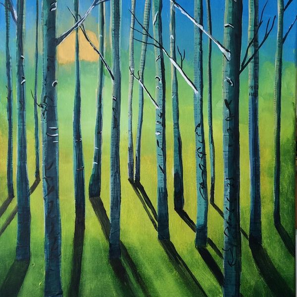 The sun rising behind a stand of trees casting reflections