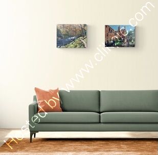 Two landscape paintings shown in a room setting