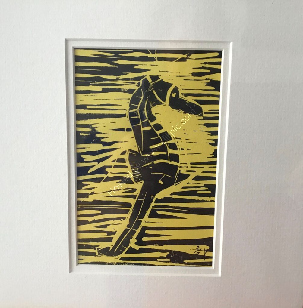 A linocut of a seahorse, printed in black on yellow