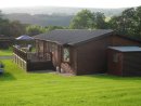 View showing back of Lodge and decking with shed