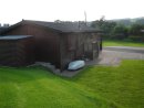 View of Lodge showing kitchen entrance and 3 car parking spaces