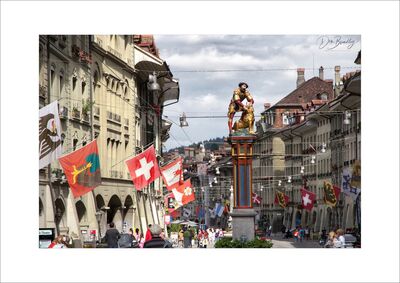 Simsonbrunnen and flags, Kramgasse. Bern, Switzerland