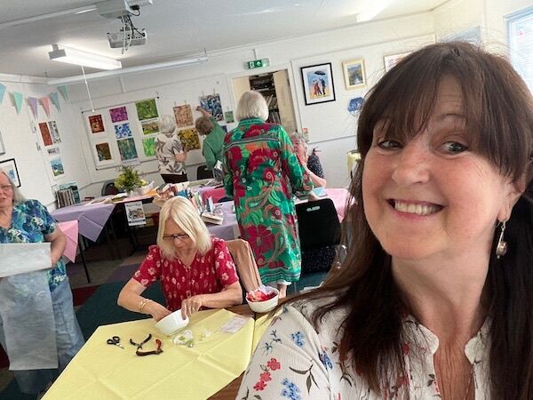 Our President looking very pleased with proceedings and Jill busy getting her beads ready