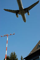 Plane landing low over house, Düsseldorf, Germany.