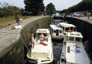 Boats in locks on the Canal du Midi, France. 1980s.