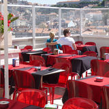 Couple with red tables and chairs, Lisbon