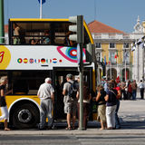 Tourists with yellow bus
