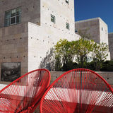 Red chairs against blue sky