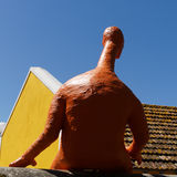 Artistic man sitting on wall