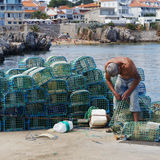 Fisherman mending lobster pots, Cascais