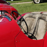 Red car with worn seats