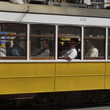 Yellow tram with passengers