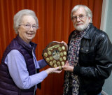 Peggy presents the Foursome Trophy to Malcolm Imhoff for winning the Audience Vote with M&M's "Love Will Remain"