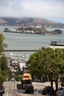 Cable car on the streets of San francisco with Alcatraz in the back ground.