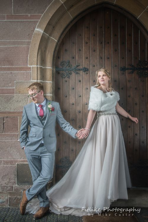 Elgin Wedding Photographer. Bride & Groom holding hands in romantic pose in a doorway.