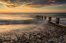 Chatter-of-the-Pebbles A sunset photograph at Findhorn Beach, Moray. The sea coming and going over the pebbles. You can almost hear them.