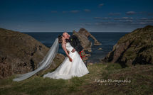 Cullen-Bay-Hotel-Wedding-Photography-05 The bride and groom posed in front of Bow Fiddle Rock, Moray.