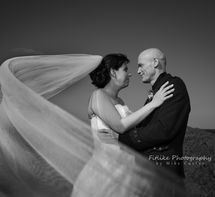 Cullen-Bay-Hotel-Wedding-Photography-06 Bride & Groom in romantic pose with a long veil framing them.