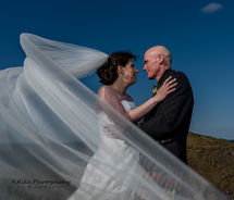 Cullen-Bay-Hotel-Wedding-Photography-07 Bride and Groom in Romantic pose with a long veil. Lit by off camera flash.