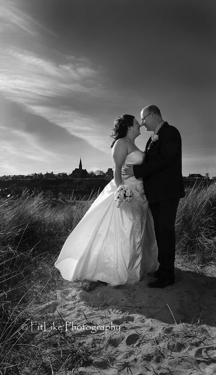Bride and Groom in Romantic pose on the beach. Lit by off camera flash.