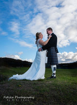 Fife-Lodge-Banff-Wedding-Photography-03 The bride and groom guided into a close embrace. Lit with off camera flash. On a sunny day in Banff, Aberdeenshire.