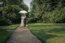 Logie-Country-House-Wedding-Photography-003 The bride and groom posed on a tree lined path on a sunny day.