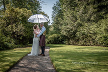 Logie-Country-House-Wedding-Photography-004 Bride and Groom posed on a tree lined path on a sunny day.