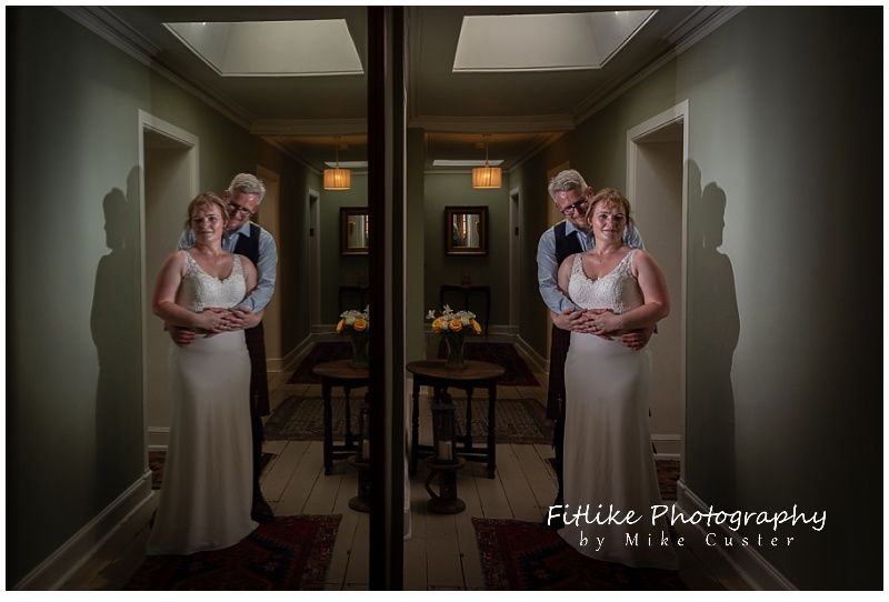 The bride and groom posed in a hallway of n old house in Dunkeld, Perthshire, Scotland. Positioned so that I could get a reflection in a wall mounted mirror.