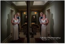 Perthshire-Wedding-Photography-02 The bride and groom posed in a hallway of n old house in Dunkeld, Perthshire, Scotland. Positioned so that I could get a reflection in a wall mounted mirror.