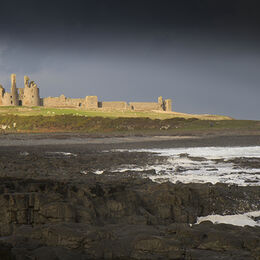 DUNSTANBURGH CASTLE: Very good image and well composed in lovely light with castle holding attention and rocks plus darker sky drawing the eye to the castle