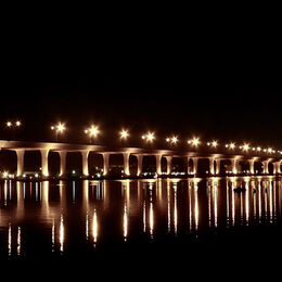 ILLUMINATED BRIDGE: Light is what picture is about. Follow the lights left to right. Light and dark with nice star effect from the lights.