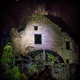 LIGHT ON THE MILL: Well lit derelict building at night. Light not too harsh. Well depicted and can see detail and shadows.
