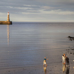 ROKER: A good minimal image with a good use of light. A well balanced image with lighthouse to the left with reflection and figures to bottom right again with reflections.
