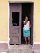 Cuban lady beckoning to enter her house