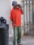 Cuban selling "Granma" Newspaper, Havana