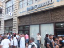 Cubans queuing to telephone at telephone exchange, Obispo Street, Havana