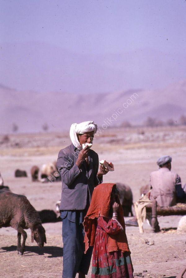Afghani Farmer & Daughter eating Water Melon, Camel Market, Kabul