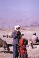 Afghani Farmer & Daughter eating Water Melon, Camel Market, Kabul