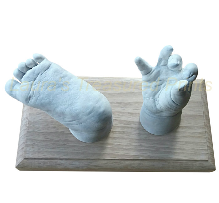 Two baby casts on wooden plinth