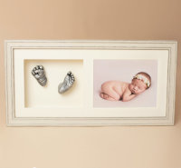 Baby casts in cream frame with photo