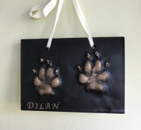 2D dog print on a black plaque