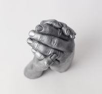 Two people holding hands- cast photo from above