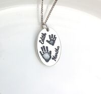 Oval silver handprint pendant