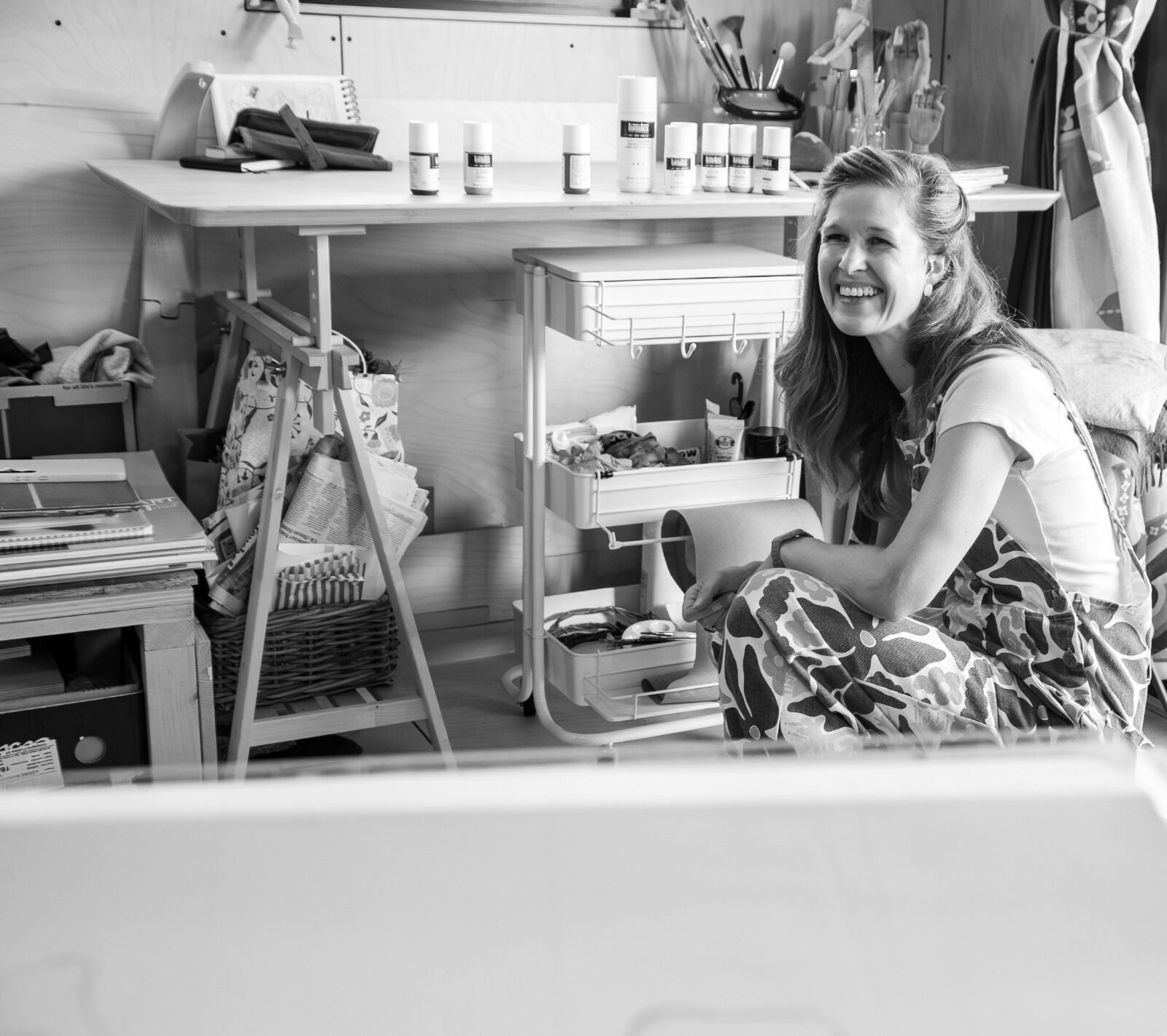 B&W studio portrait crouch